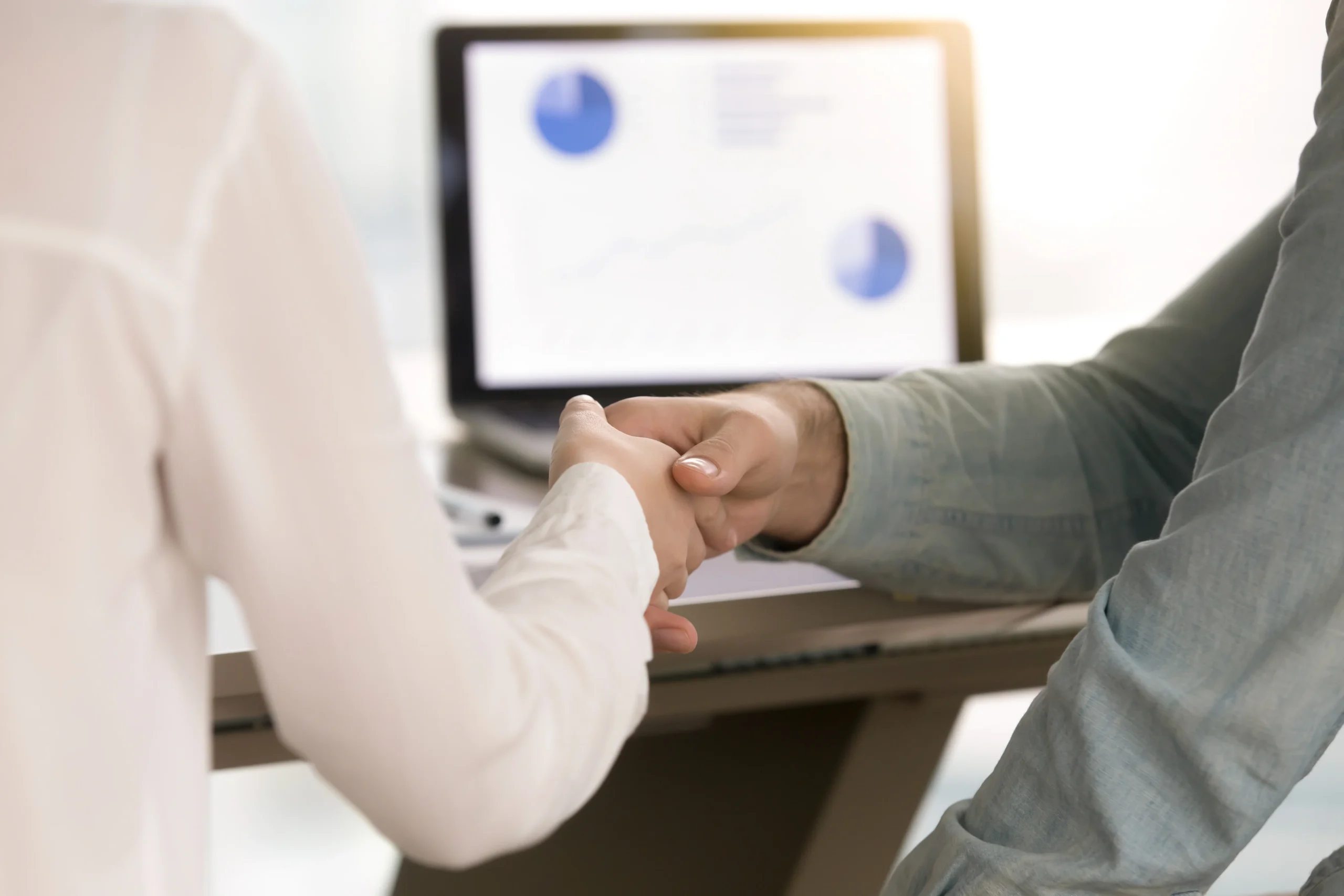 businessman businesswoman shaking hands after making profita scaled