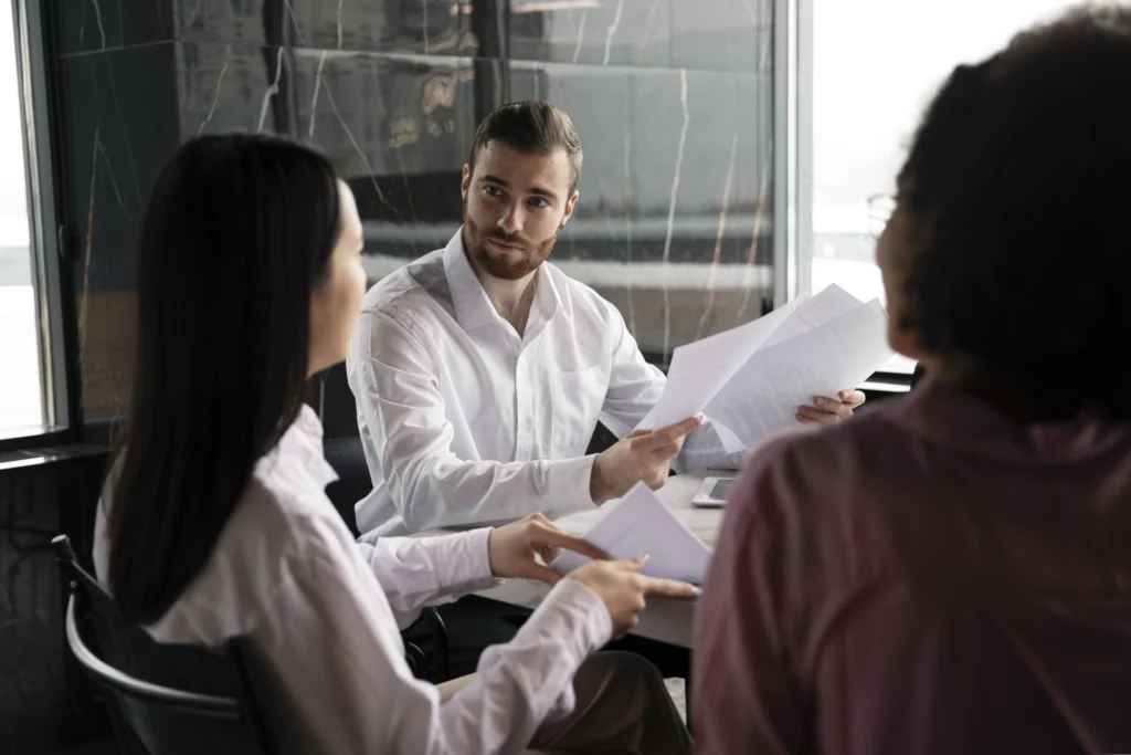 man showing his workmates documents